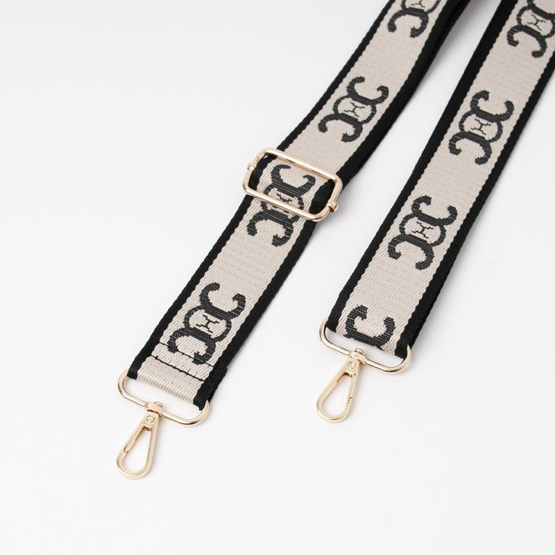 Skulderrem beige og svart - veskereim med mønster og gullfarget metall